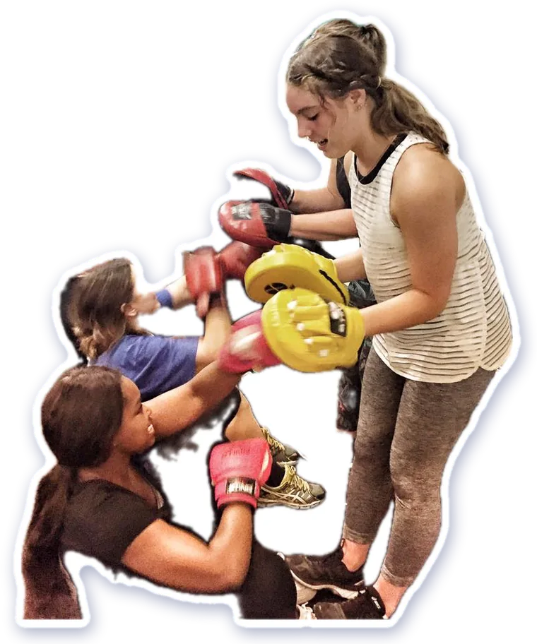 Members doing partner pad work in a group class