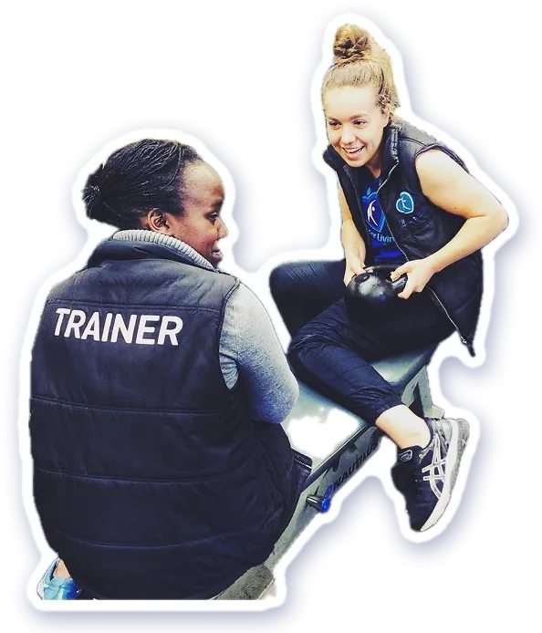 A trainer coaching a member on the bench