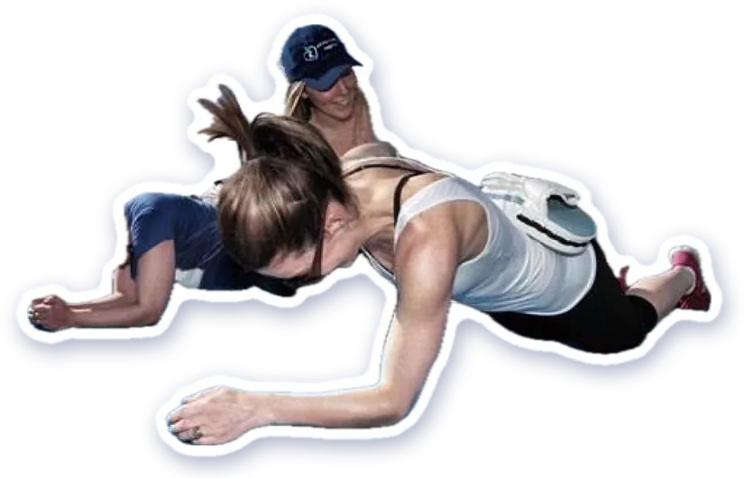 A trainer coaching a member through a plank by the water